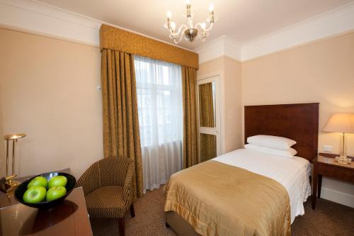 a hotel room with a bed and a window at Macdonald Burlington Hotel in Birmingham