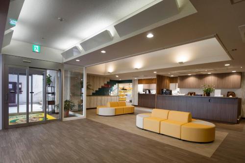 an office lobby with yellow chairs and a counter at Izumigo Izukogen Dog Paradise Condominium in Ito