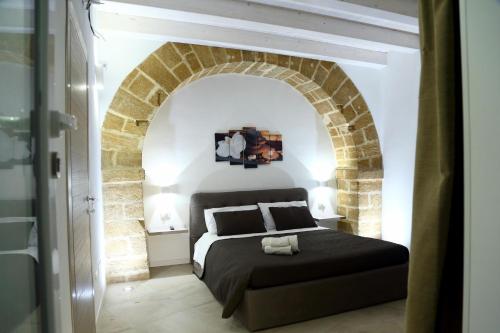 En eller flere senge i et værelse på Appartamenti Maniace