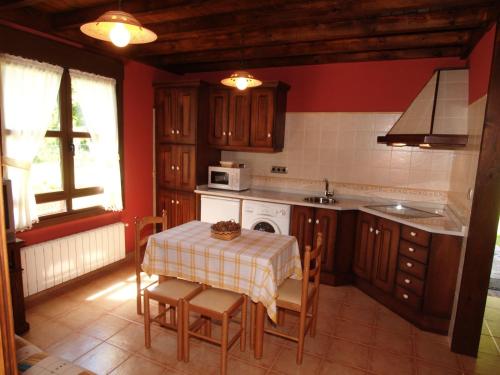 a kitchen with a table and a stove top oven at Ribera del Sella in Cangas de Onís