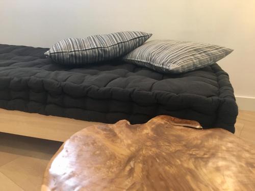 a bed with two pillows on top of it at MD Design Hotel - Portal del Real in Valencia