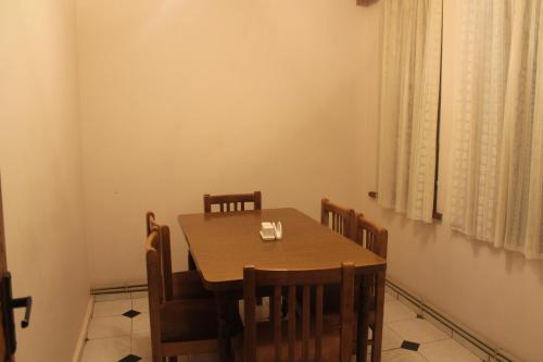 a dining room with a wooden table and chairs at Hotel Restaurant Kakhaberi in Bibiliani