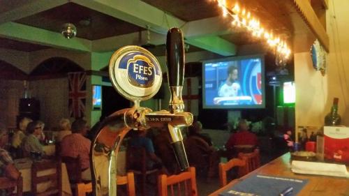 a bar with a beer dispenser in a restaurant at Paradise in Kérynia