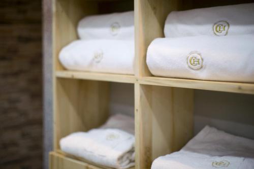 a shelf filled with lots of white towels at Central Hotel Yerevan in Yerevan