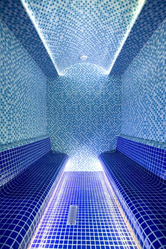 a blue room with blue tiles on the ceiling at Central Hotel Yerevan in Yerevan