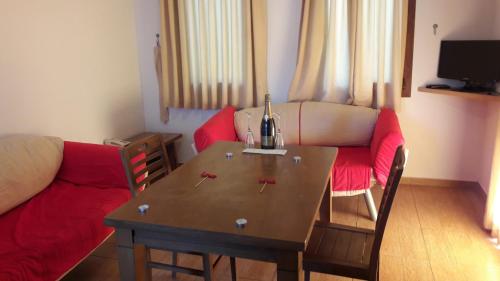 a living room with a table and a couch at Ozukara Apart 1 in Gümbet