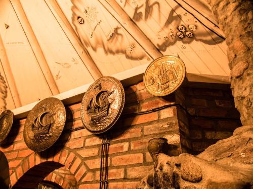 a group of copper coins hanging on a wall at Agroturystyka u Karoliny in Sarbinowo
