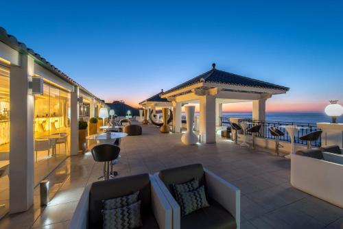 a hotel patio with a view of the ocean at Gran Hotel Miramar GL in Málaga