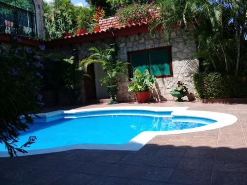 a swimming pool in front of a house at Casa Costera Miguel Alemán in Acapulco
