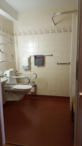 a bathroom with a toilet and a sink at Highway Hotel in Härnösand