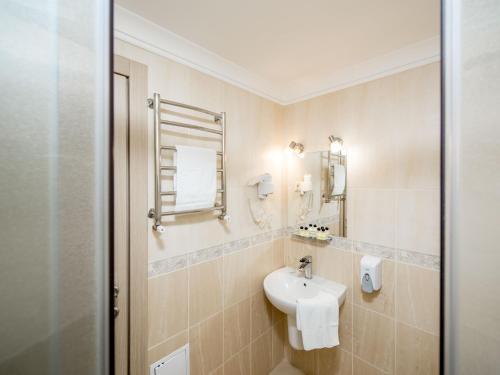 a bathroom with a sink and a mirror at Hotel&SPA Pysanka, Готель Писанка, 3 сауни та джакузі - індивідуальний відпочинок у СПА in Lviv