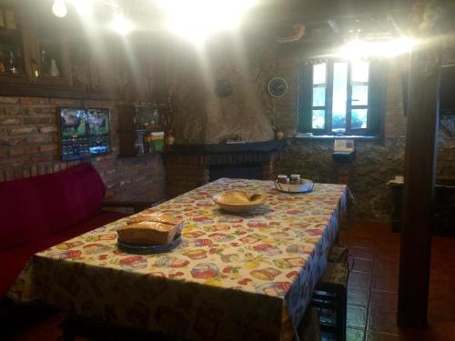 a table with a table cloth on it with two bowls on it at La Xica in Beceña