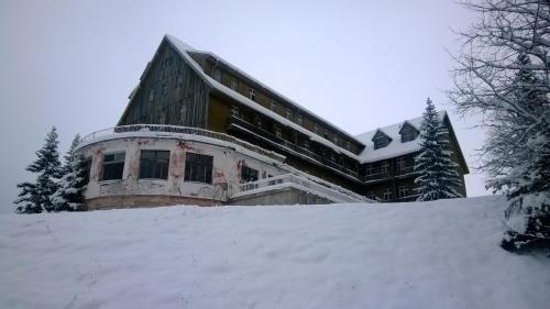a building on top of a pile of snow at Guesthouse Andrea A in Žabljak