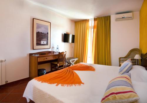 Habitación de hotel con cama y escritorio en Solar dos Marcos Rural Accommodation en Bemposta