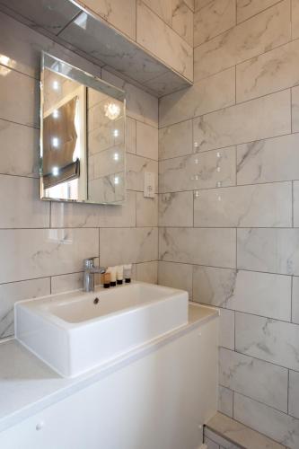 a bathroom with a white sink and a mirror at Winstanley House in Leicester