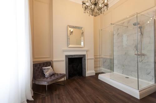 a bathroom with a shower and a fireplace at Winstanley House in Leicester