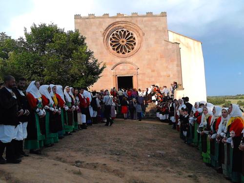 a group of people standing in front of a church at B&B I Menhir in Sorgono