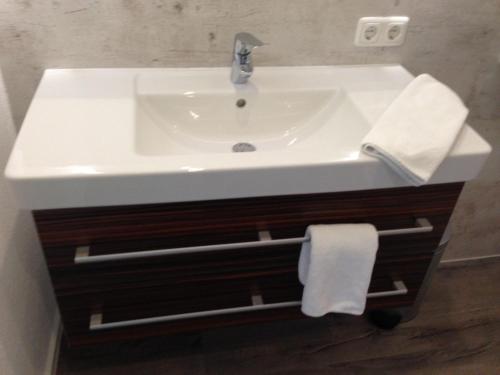 a white sink in a bathroom with a towel at Appartements Strasser Angelika in Westendorf