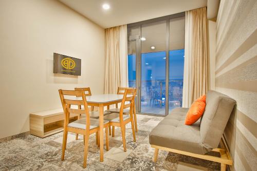 a dining room with a table and chairs and a window at Ameri Plaza Tbilisi in Tbilisi City