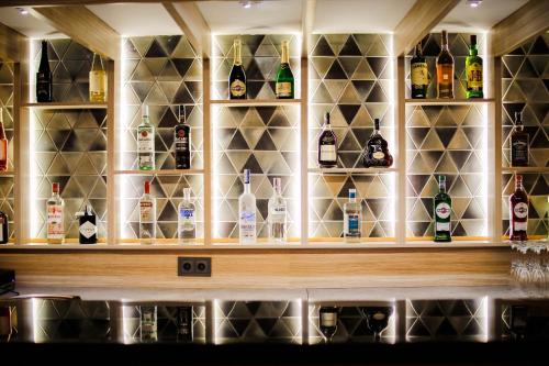 a bar with a lot of bottles of alcohol at Ameri Plaza Tbilisi in Tbilisi City