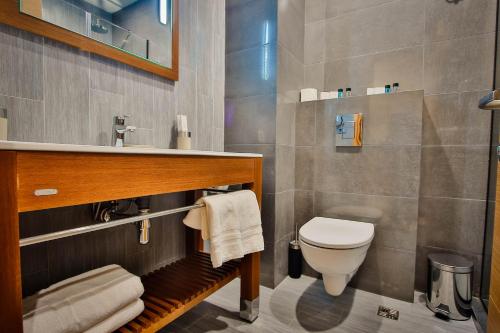 a bathroom with a toilet and a sink at Ameri Plaza Tbilisi in Tbilisi City