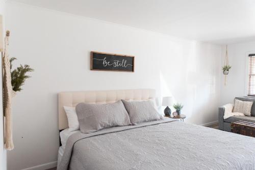 a bedroom with a bed and a sign on the wall at The Carriage House at Strasburg in Strasburg