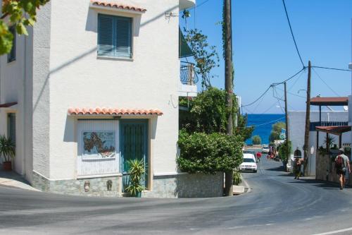 a white building on the side of a street at George Apartments in Livadia