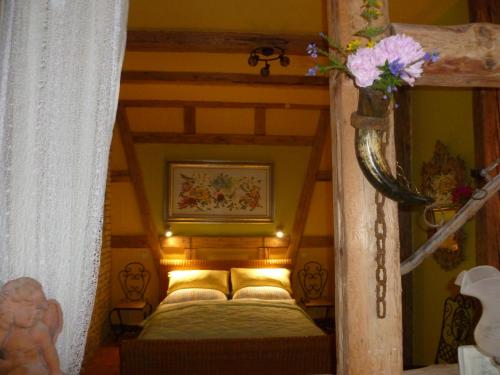 a bedroom with a canopy bed with yellow pillows at Ferienwohnungen Klosterblick in Walkenried