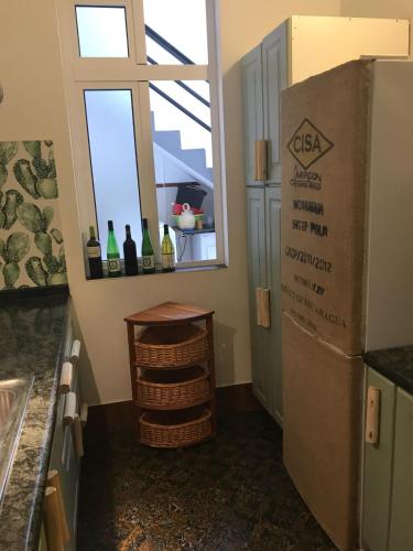 a kitchen with a window and bottles of wine at Cactus Host in Las Palmas de Gran Canaria