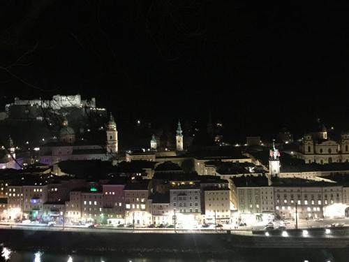a view of a city at night with lights at Hotel Vogelweiderhof in Salzburg
