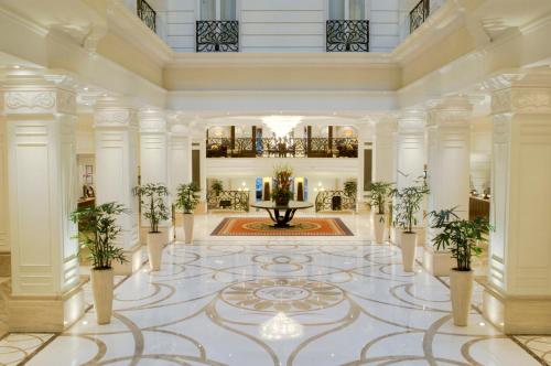 a lobby with a fountain and plants on the floor at Corinthia Budapest in Budapest