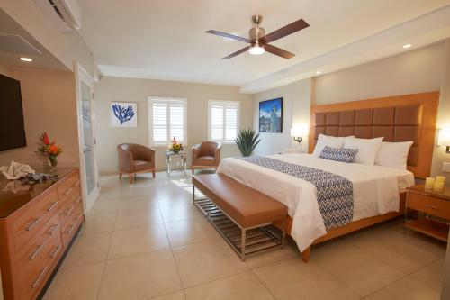 a bedroom with a large bed with a ceiling fan at Divi Dutch Village Beach Resort in Palm-Eagle Beach