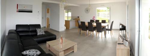 a living room with a black couch and a table at La Marina in Chassieu