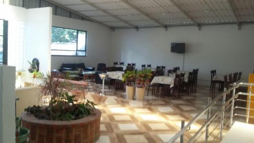 a dining room with tables and chairs in a room at Hotel Gabriel in Santa Maria