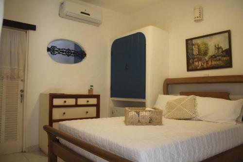 a bedroom with a bed with a basket on it at Aquarius Osteria in Arraial do Cabo