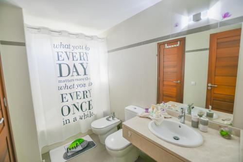 a bathroom with a toilet and a sink and a mirror at Casa Zen in Puerto Calero