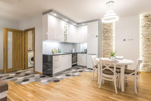 kuchnia i jadalnia ze stołem i krzesłami w obiekcie Apartament 48m w centrum Grójca w mieście Grójec