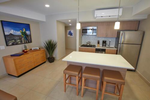 a kitchen with a white counter and a refrigerator at All Inclusive - Divi Dutch Village Beach Resort in Palm-Eagle Beach