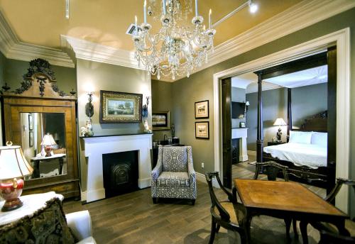 a living room with a bed and a chandelier at The Inn at Houmas House Estate in Darrow
