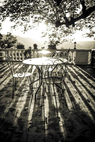 a table and two chairs sitting around a table at Logis Hôtel La Bellaudière in Grasse