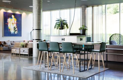 a kitchen with a table and chairs in a room at Comfort Hotel Bergen Airport in Bergen