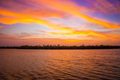 a sunset over a body of water at Tintipan Cabana SalSiPuedes in Tintipan Island