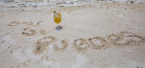 a word written in the sand on a beach at Tintipan Cabana SalSiPuedes in Tintipan Island