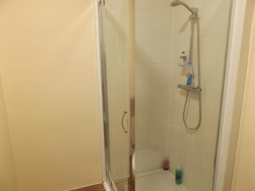 a shower in a bathroom with a glass shower stall at Cotesheath house in Etruria