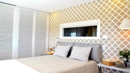 a bedroom with a bed and a window at Panorama Penthouse in Espinho