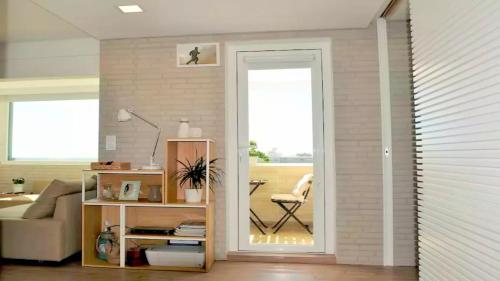a living room with a door open to a living room at Panorama Penthouse in Espinho