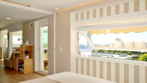 a bedroom with a window with a view of the city at Panorama Penthouse in Espinho