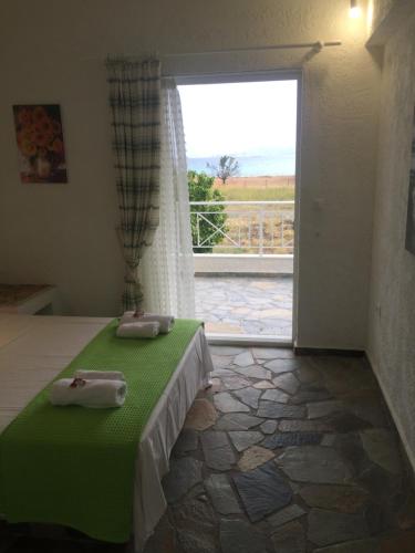 a bedroom with a bed and a window with a view at Phoenix Beachside Condos in Kokóni
