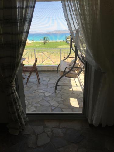 an open door to a patio with a view of the ocean at Phoenix Beachside Condos in Kokóni