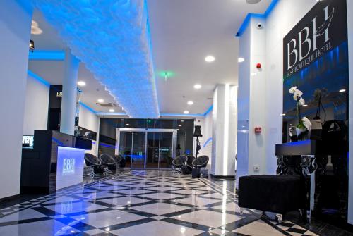 a lobby with black chairs and a blue ceiling at Best Boutique Hotel in Stara Zagora